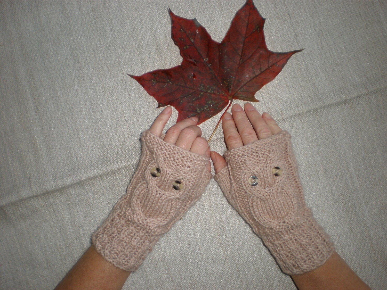 Hand-knitted beige color wrist warmers with knitted owl