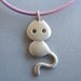 Little cat with leather cord