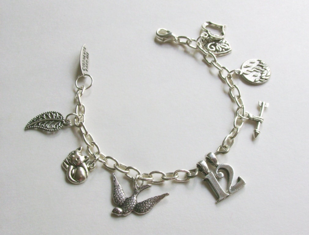 The Hunger Games charm bracelet mockingjay district 12 arrow fire inspired by The Hunger Games movie and books