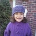 Purple Hat with a big white  flower