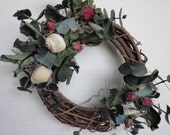 Wreath grapevine with seashells, sea glass and dried roses.