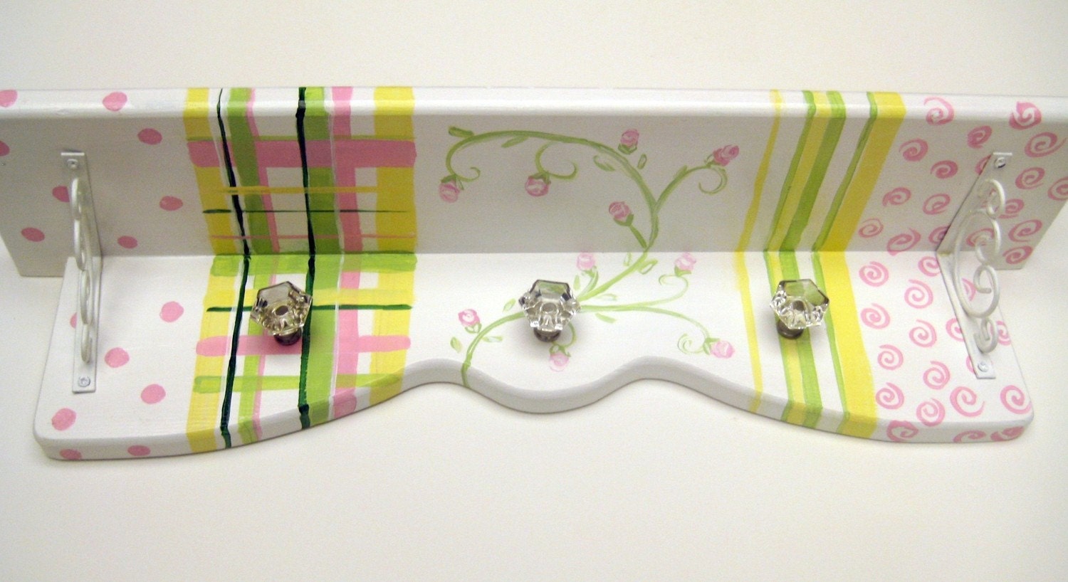 A hand painted shelf  customized to co ordinate with all the colors and patterns of the nursery with plaid, stripes and polka dots