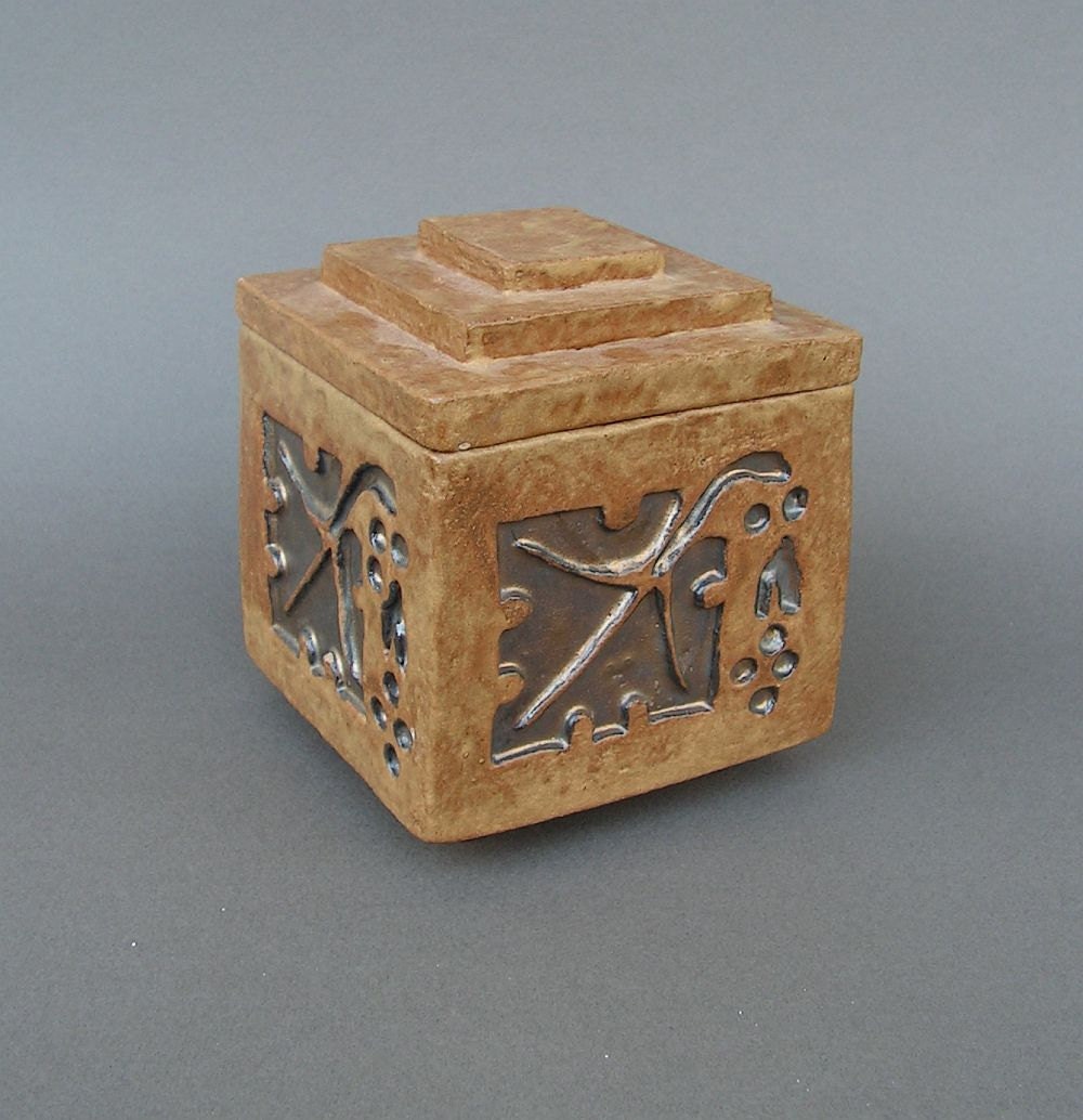 Tan and gold lidded box with Arts & Crafts grape leaf design