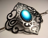 Gunmetal copper and sterling silver bracelet with frosted blue mirrored glass cabochon