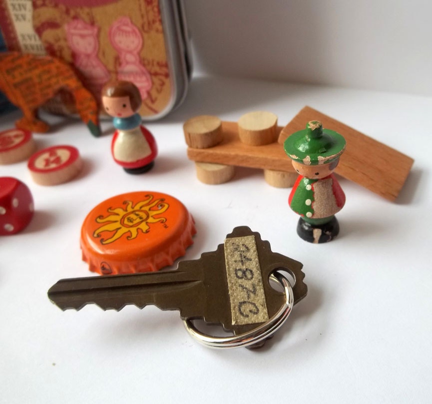 Toy set in a tin, pocket size amusement kit for kids, with vintage Sevi figures, wooden game pieces, and other random items