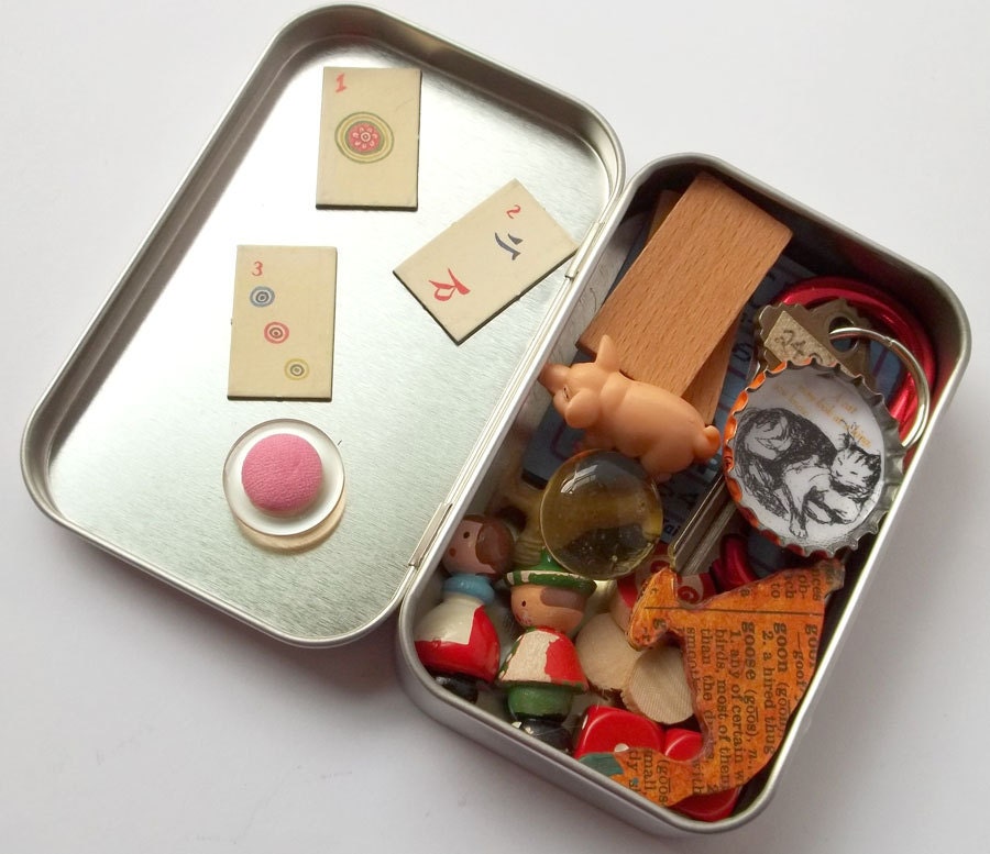 Toy set in a tin, pocket size amusement kit for kids, with vintage Sevi figures, wooden game pieces, and other random items