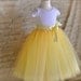 The Daffodil Tutu for Flower Girls. Six layers of butter yellow, lemon yellow and ivory tulle is sewn.