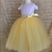 The Daffodil Tutu for Flower Girls. Six layers of butter yellow, lemon yellow and ivory tulle is sewn.