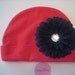 Husker Soft and Sassy Red Cotton Infant Hat with Adorable Black Flower