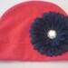 Husker Soft and Sassy Red Cotton Infant Hat with Adorable Black Flower
