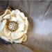 Ivory flower clip with a jewel center
