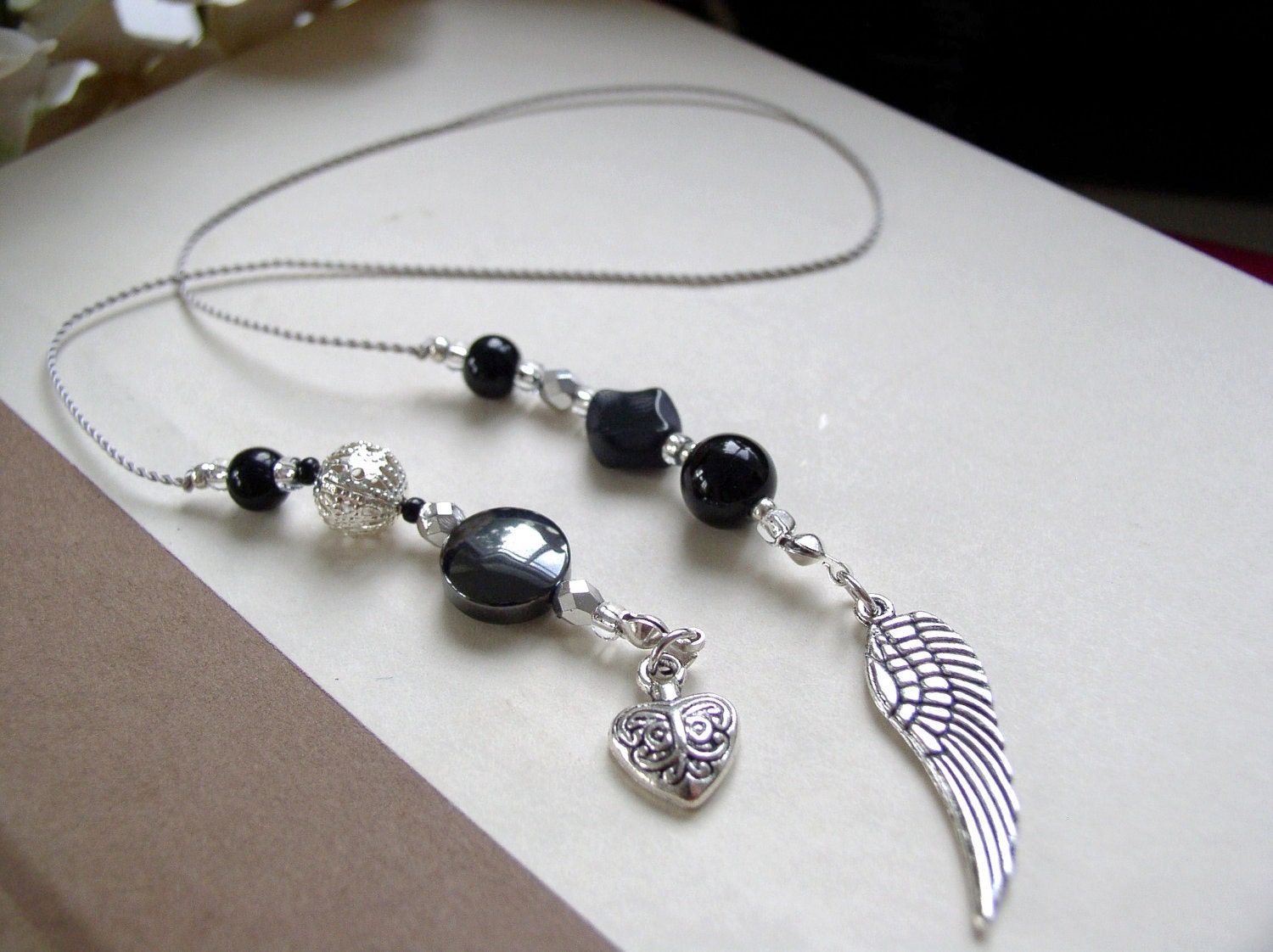 Fallen Angel Bookmark  - Jeweled Beaded Book Thong  in Black and Silver with Angel Wings and Heart Charms