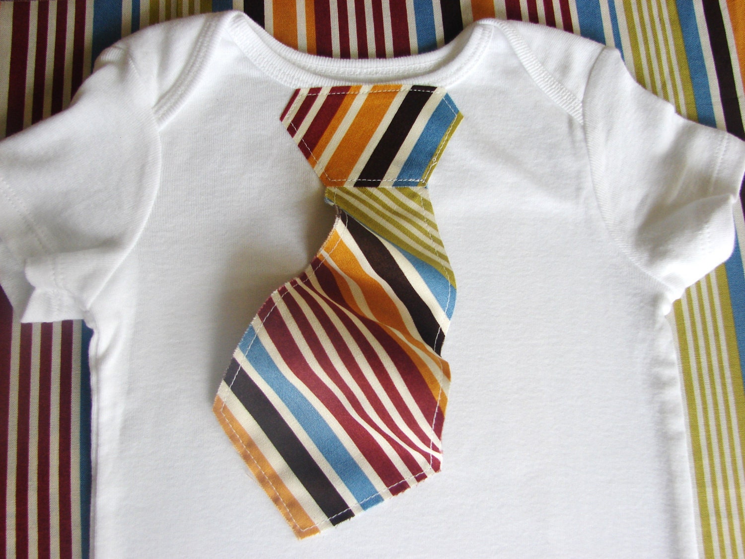 Tie ONESIE The 3D Tie ONESIE in Warm Stripes