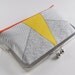 Clutch purse with yellow triangle