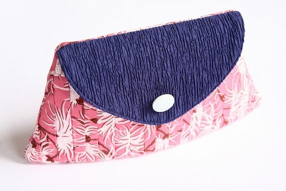 The pink flowered clutch with blue flap and white button