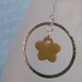 Silver hoop earrings with yellow clay flower