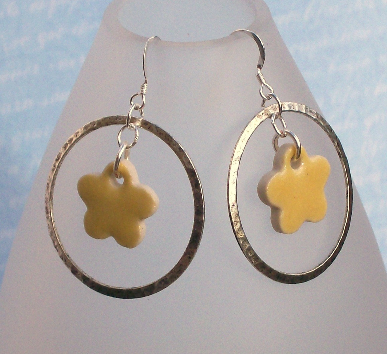 Silver hoop earrings with yellow clay flower