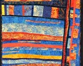 Abstract art wall quilt geometric shapes in blue and orange