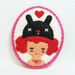 A Black Bunny and a Girl felt pin