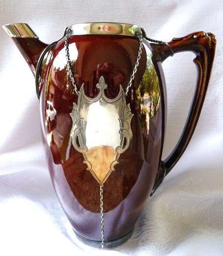 Sterling silver mounted pottery pitcher