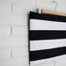 Oversized Black and white striped zippered clutch.