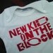 funny baby onesie New Kids on the Block hand stenciled and spray painted tshirt by Rainbow Alternative on Etsy