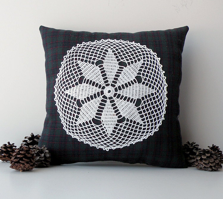 Small red, green and blue plaid decorative pillow with white doily