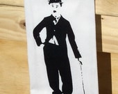 Cotton huck tea towel or dish cloth with Charlie Chaplin hand screen print in black fabric ink and decorative trim at bottom
