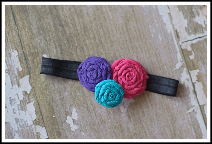 Turquoise purple and hot pink rolled fabric rosette for  newborn baby infant girl toddler on a black shimmery elastic headband