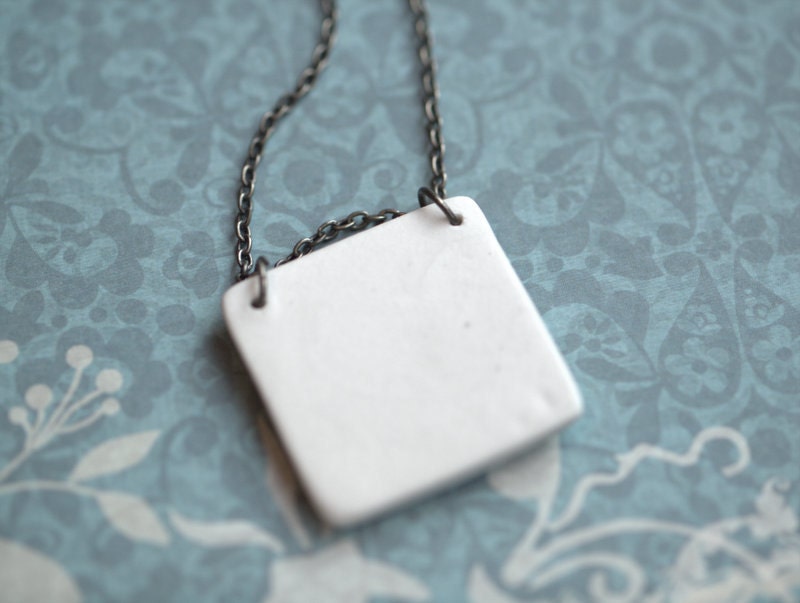 Earthy Porcelain Pendant with Impression of small leaves.