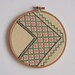Pair of vintage embroidered zig zag wall art hoops