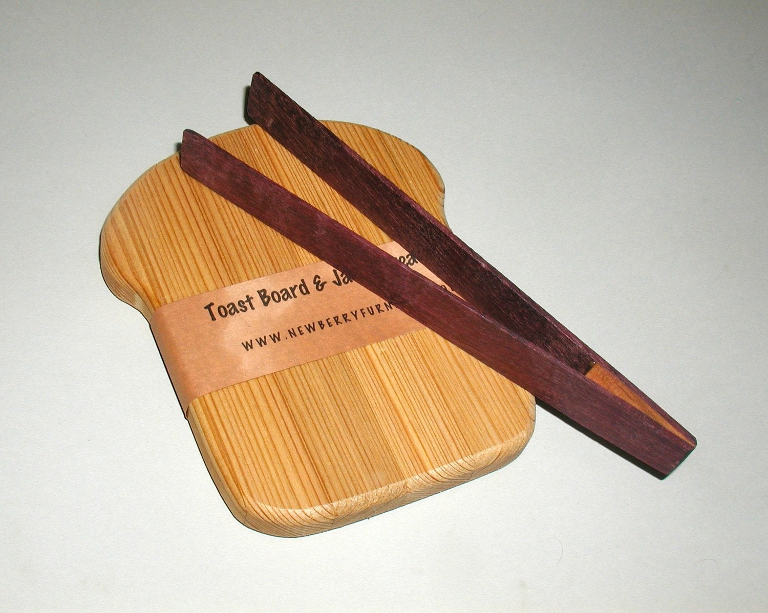 slice of bread board and toast tongs
