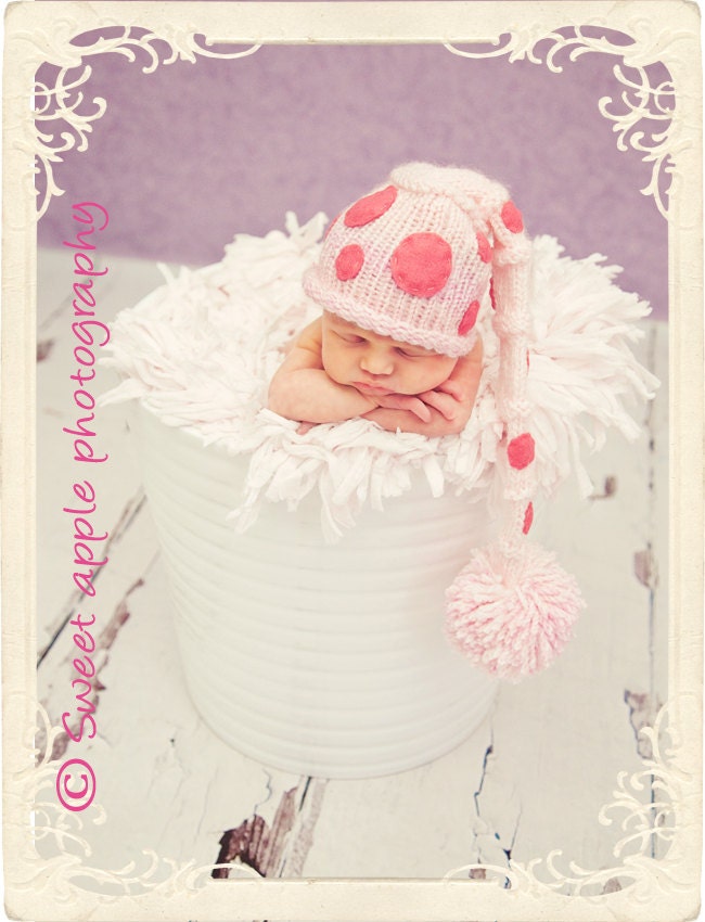 pink and white pom pom hat