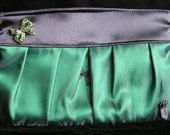 Emerald green and black satin clutch