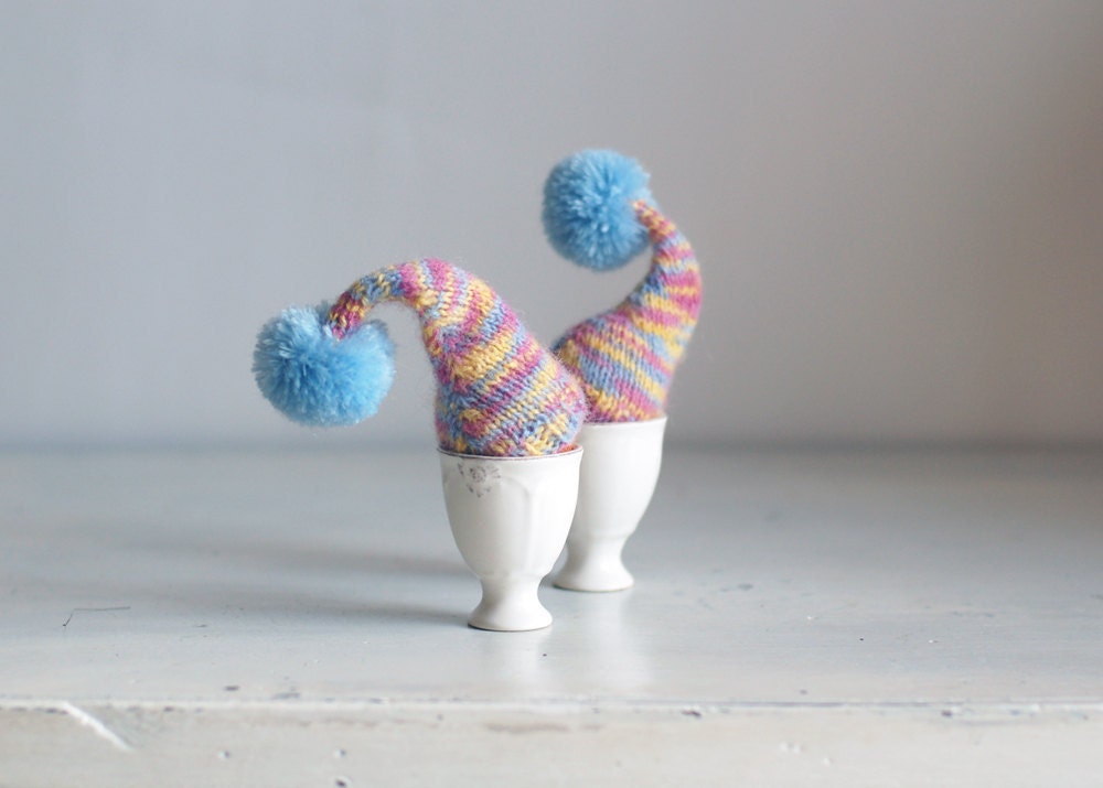 Multicolor egg cozies with blue poms