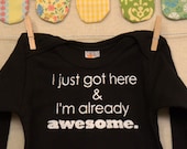 I just got here & I'm already awesome  --- black long sleeved onesie size 0-3 months.