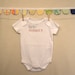 birth: nailed it --- white onesie, size 0-3 months --- pink