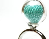 Teal microbeads in hand blown glass silver tone ring