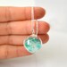 Icy teal heart glitter in blown glass ball silver necklace