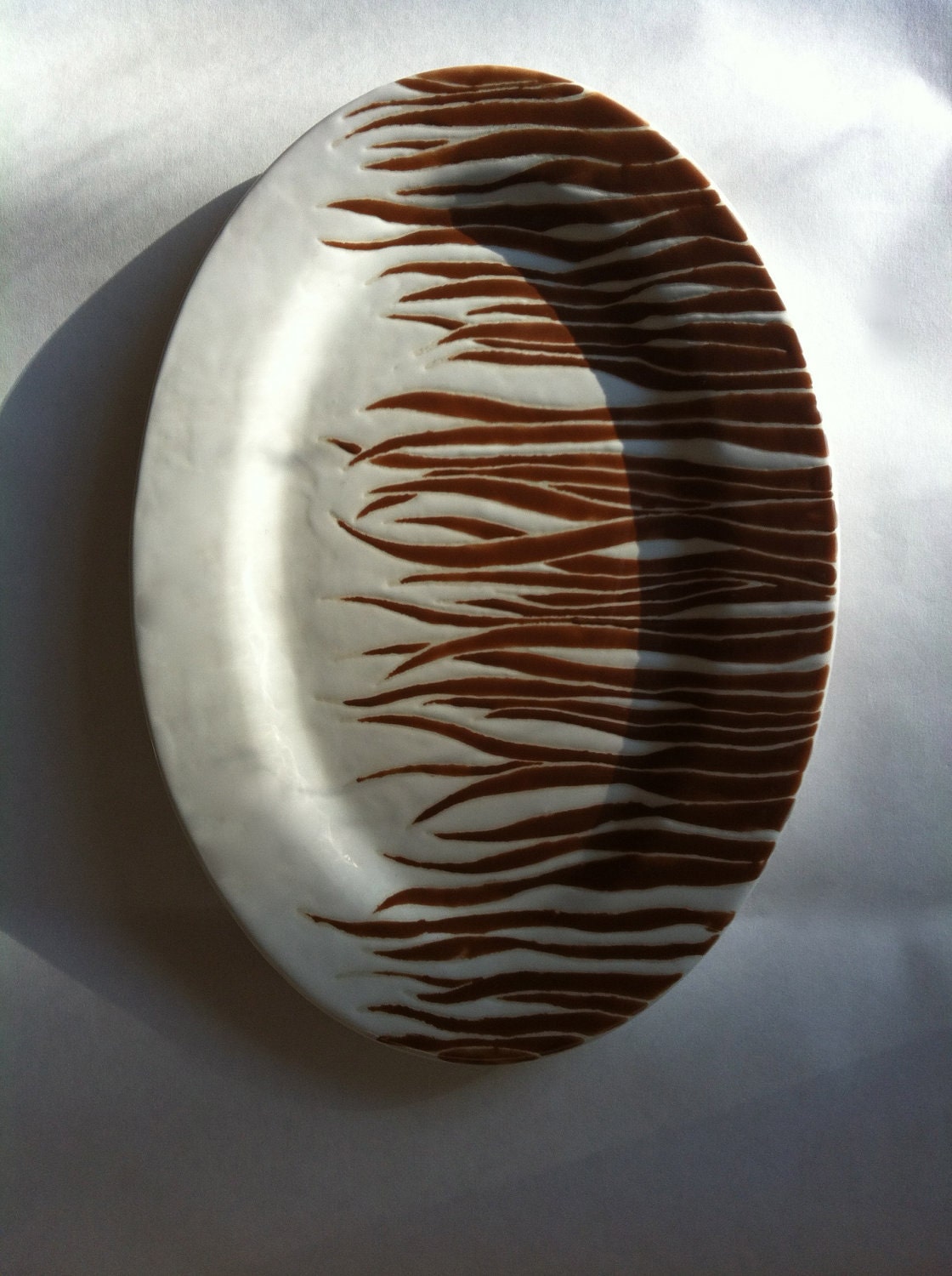 Brown oval serving plate with grass pattern