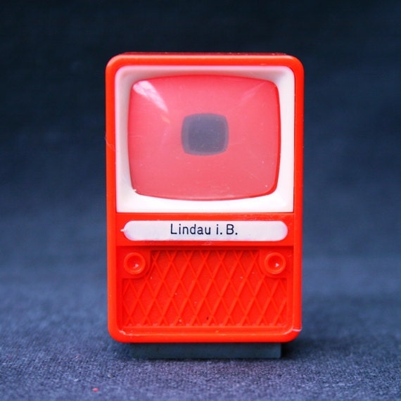 What is on telly tonight. Vintage red toy TV viewer. Souvenir from Germany.