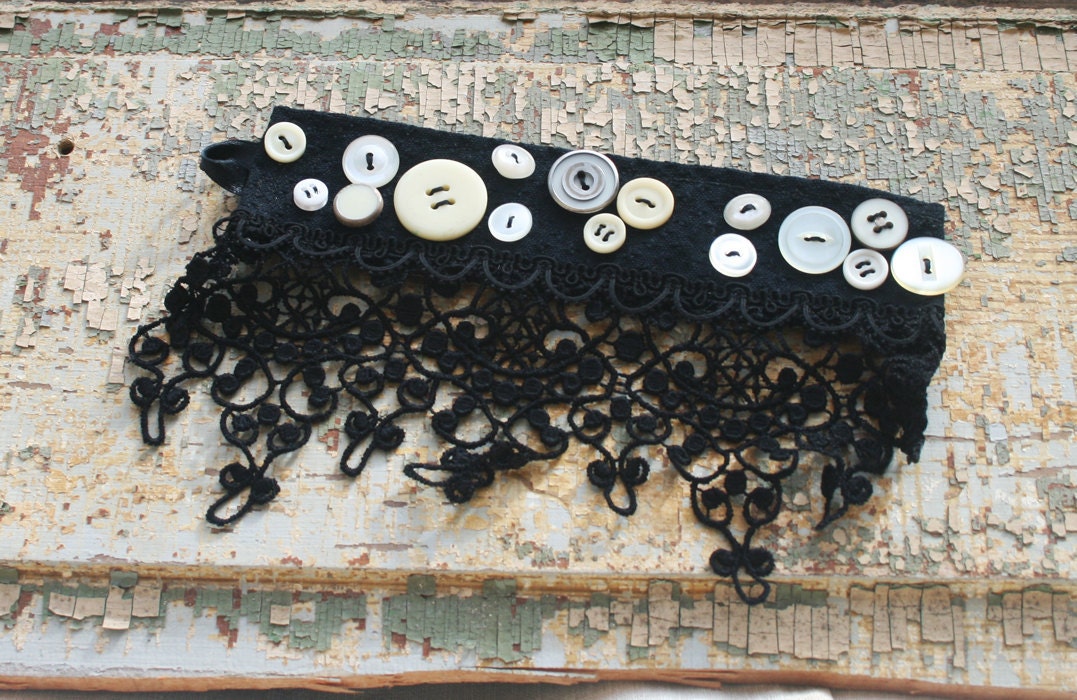 Black lace cuff with white and cream vintage buttons