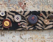 Tan and black bracelet with tortoiseshell and brass vintage buttons