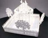popup card with birdcage and picket fence