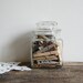Vintage apothecary jar of clothespins