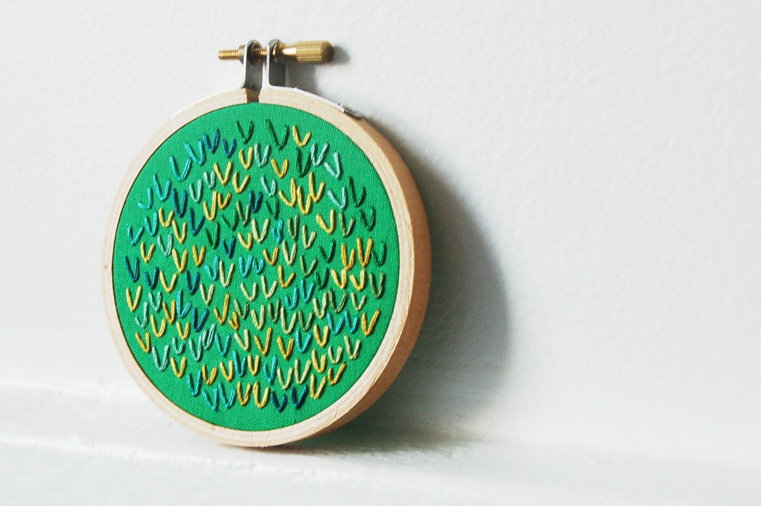 Hand Embroidered Hoop . Small Fiber Art. Green with Yellow, Teal, Blue Threads. Circle Art. by merriweather council