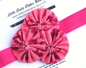 Elastic yoyo headband fabric flowers in shades of berry and pink