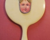 VINTAGE CELLULOID HAND MIRROR WITH APPLIQUE