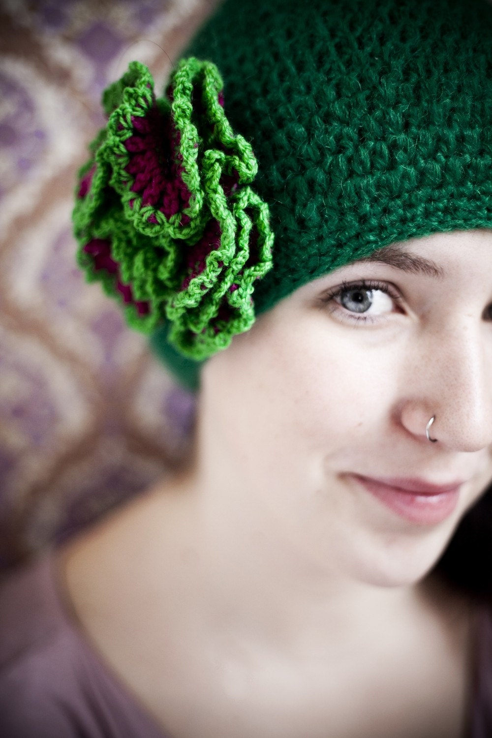 green woolen crochet beanie with fuchsia flower