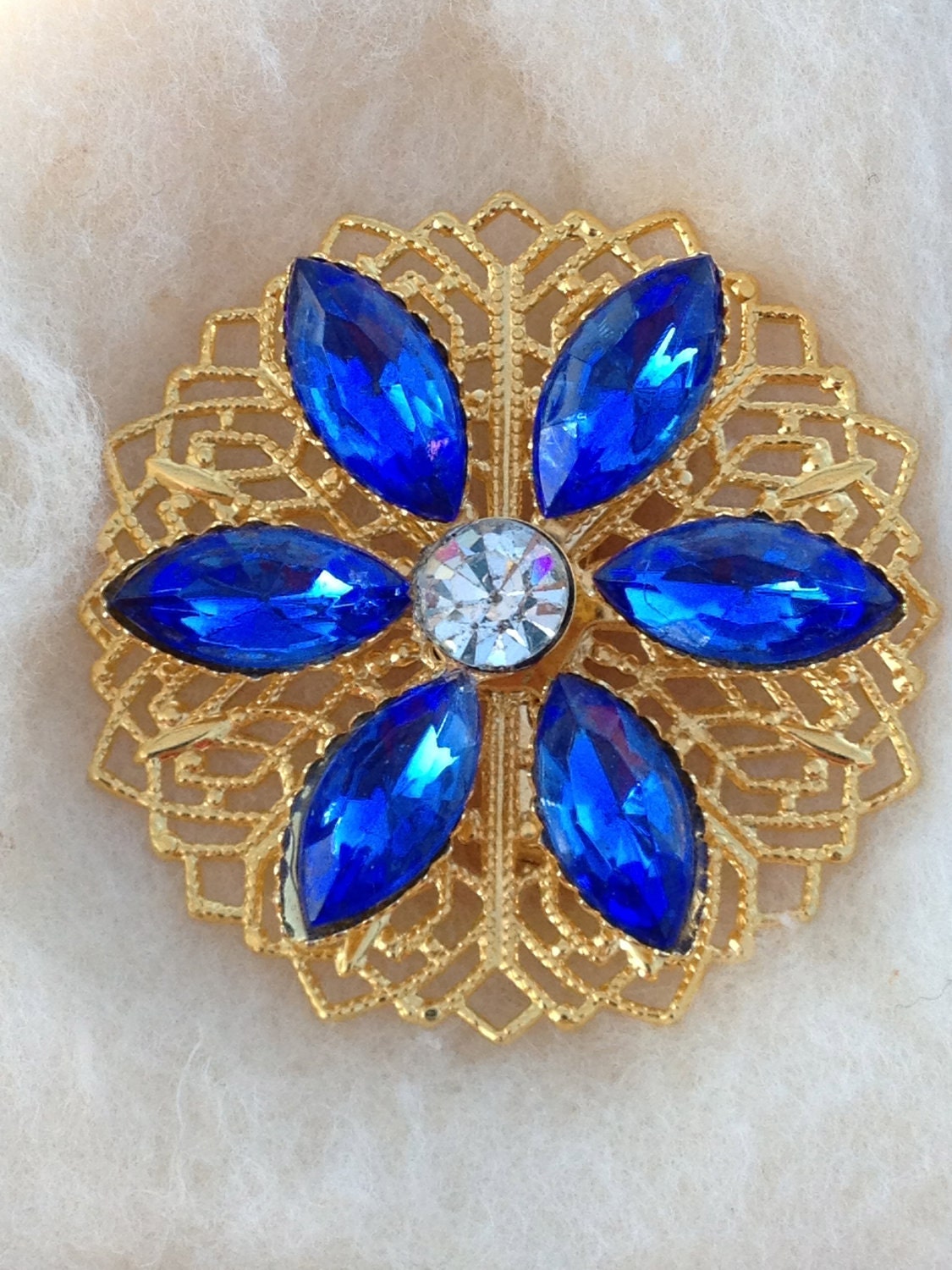 Gorgeous vintage gold tone and blue rhinestone filigree brooch